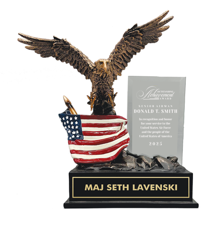 Statue of an eagle with outstretched wings holding an American flag, on a black base with engraved text. Norfolk, VA