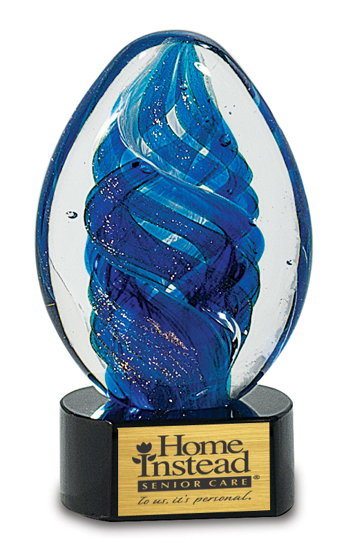 Blue glass award with 'Home Instead Senior Care' logo on a black base