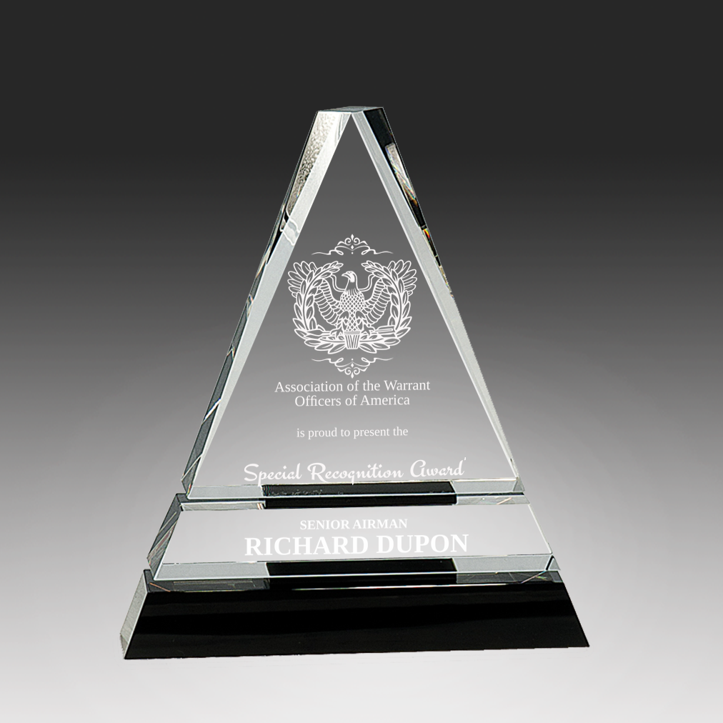 Clear glass pyramid-shaped award with engraved text and logo on a dark background in Norfolk, Virginia