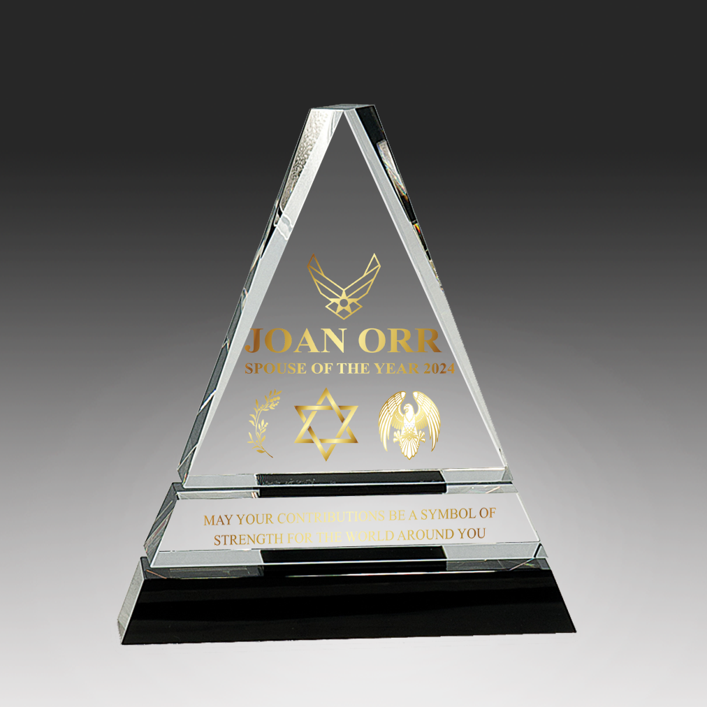 Triangular glass award with engraved text and symbols on a dark background in Virginia Beach, VA