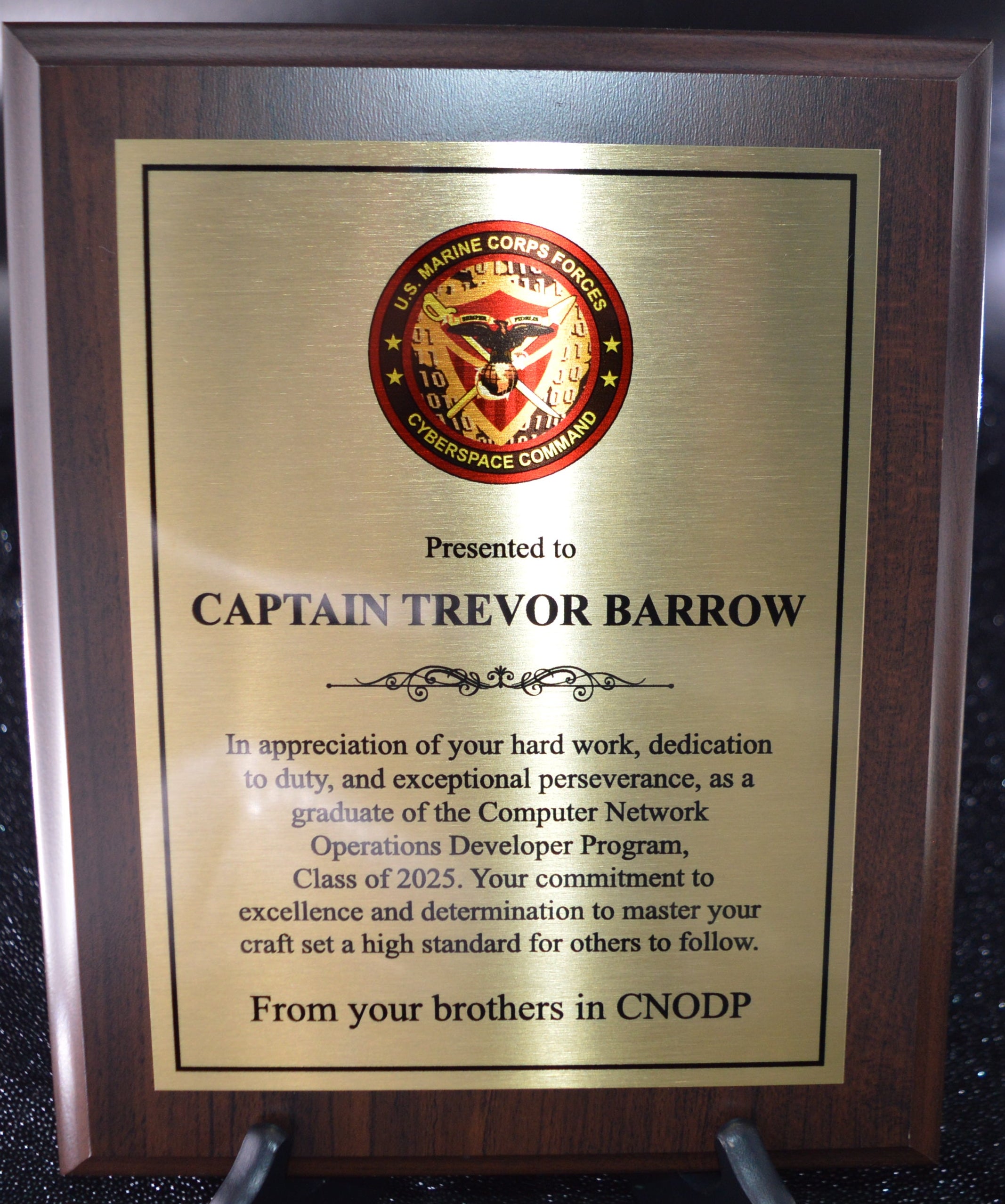 Plaque presented to Captain Trevor Barrow on a reflective surface