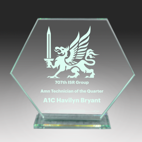 Glass award with engraved dragon and text on a dark background