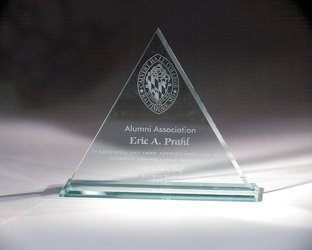 Glass TRIANGLE trophy with engraved text and logo on a dark background