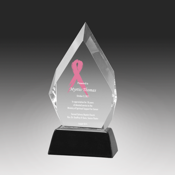 Acrylic award with pink ribbon and engraved text on a black background