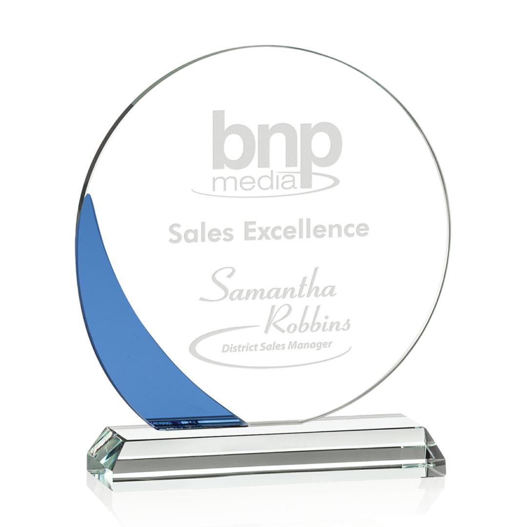 Glass award with blue accent and engraved text on a white background