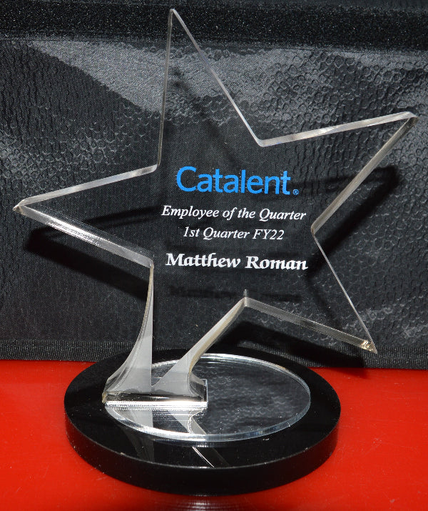 Star-shaped award with 'Catalent' branding on a black and red background
