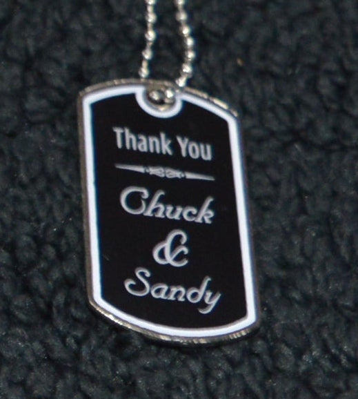 Two dog tags on a black surface