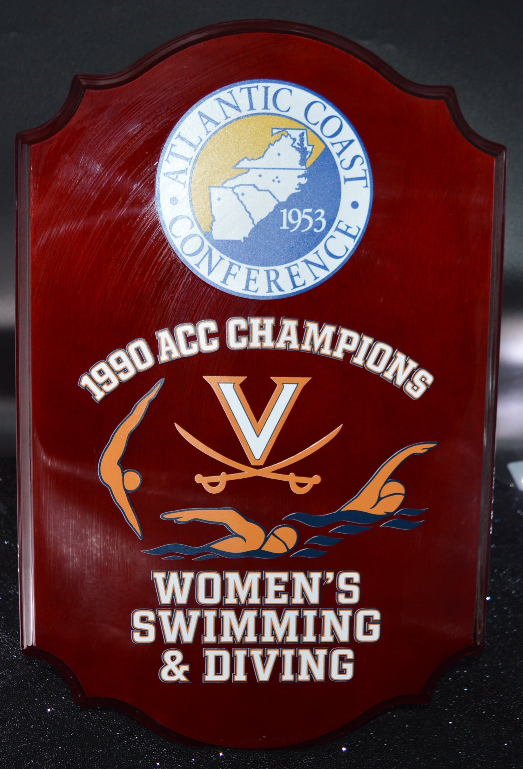 Plaque commemorating 1990 ACC Champions for Virginia Women's Swimming & Diving on a dark background.