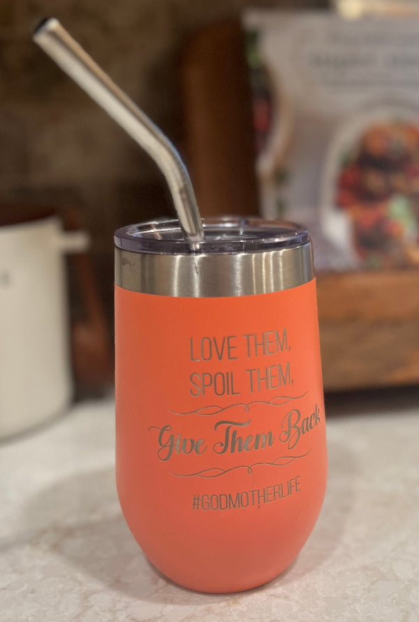 Orange tumbler with a straw on a kitchen counter
