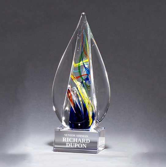 Glass award with colorful interior and engraved name on a gray background in Norfolk, VA