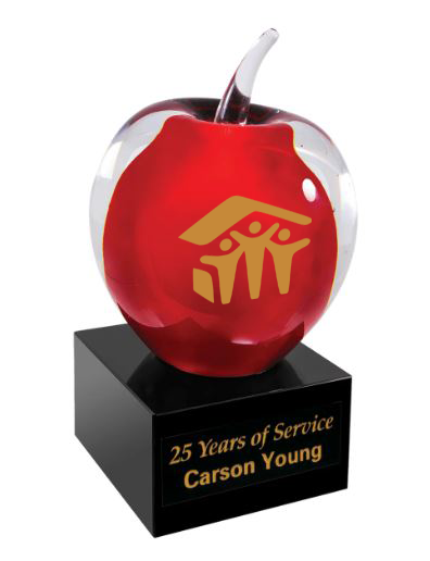 Red glass apple with gold emblem on a black base, featuring '25 Years of Service Carson Young' text. Baltimore, Maryland