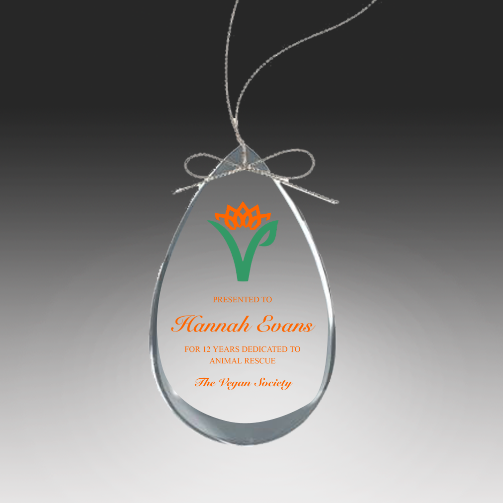 Teardrop-shaped glass ornament with UV printd text and logo on a dark background in Baltimore, Maryland