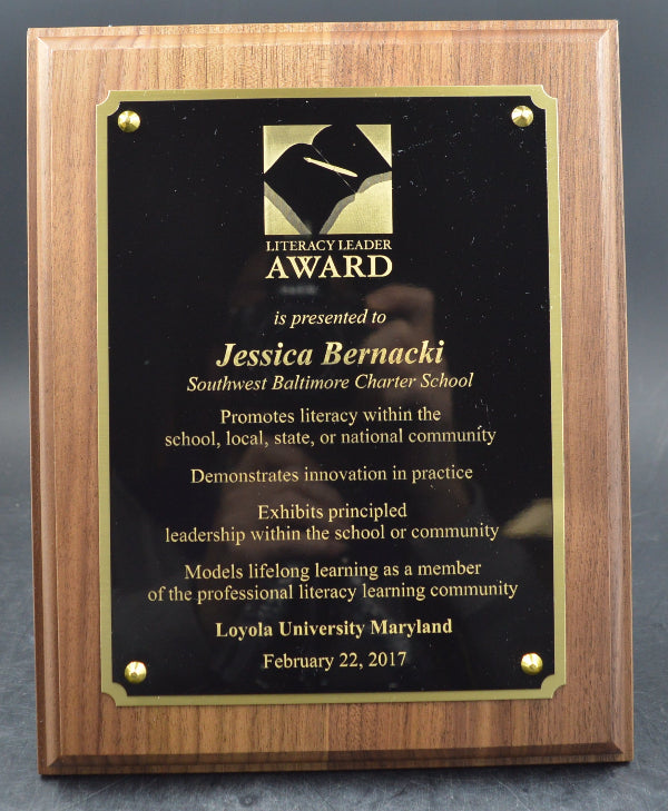 Wooden plaque with a black award certificate on a gray background