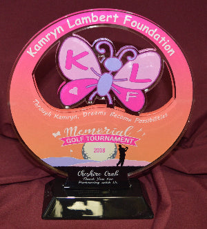 Memorial golf tournament trophy with butterfly design on a red background